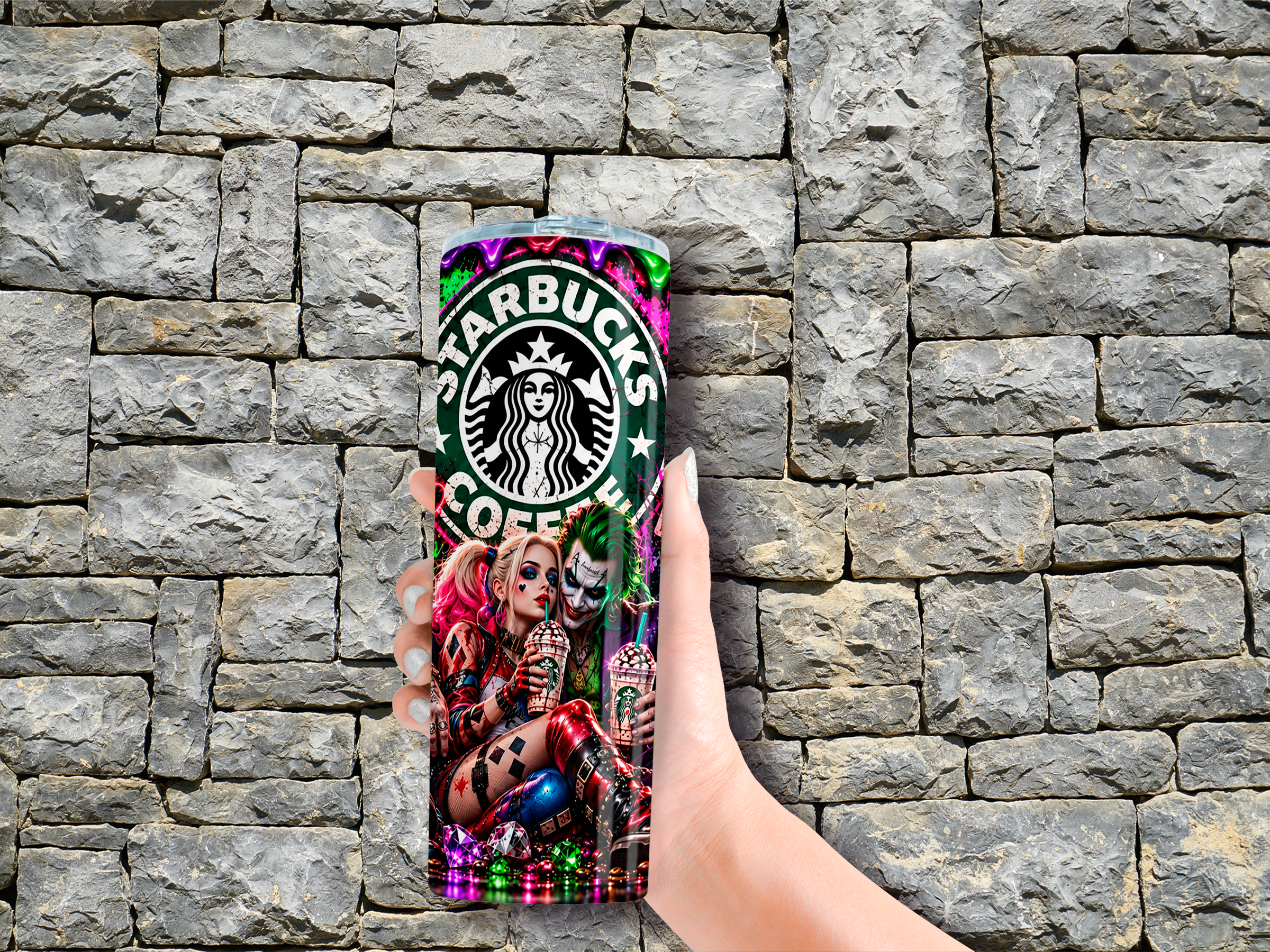Colorful 20 oz tumbler held against a stone wall